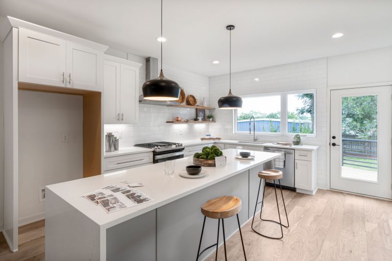 Home 21 Bright modern kitchen with white cabinetry wooden stools and 1792515725